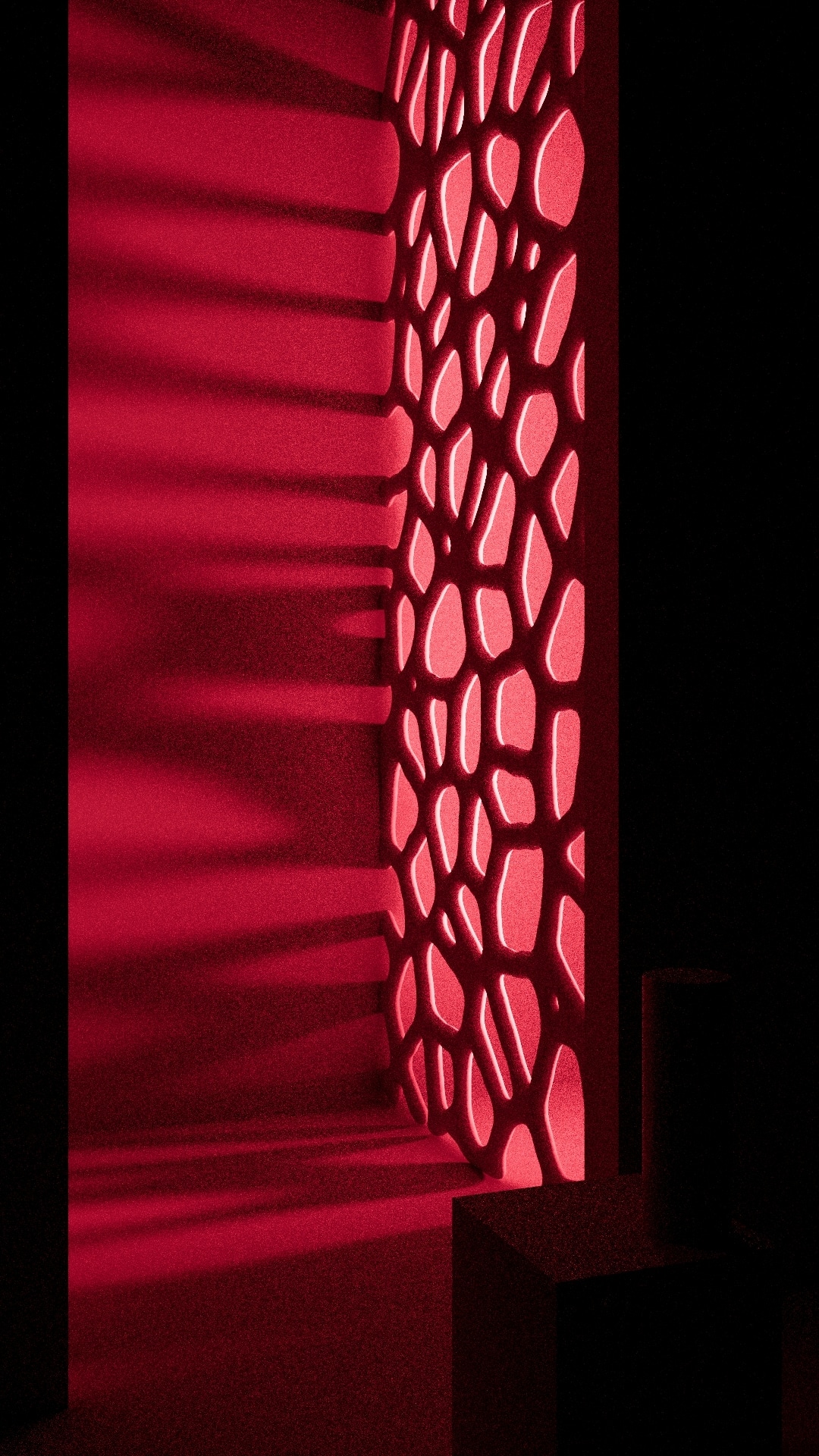 Crimson-lit room where a perforated organic-pattern wall panel casts cellular shadows beside a dark plinth