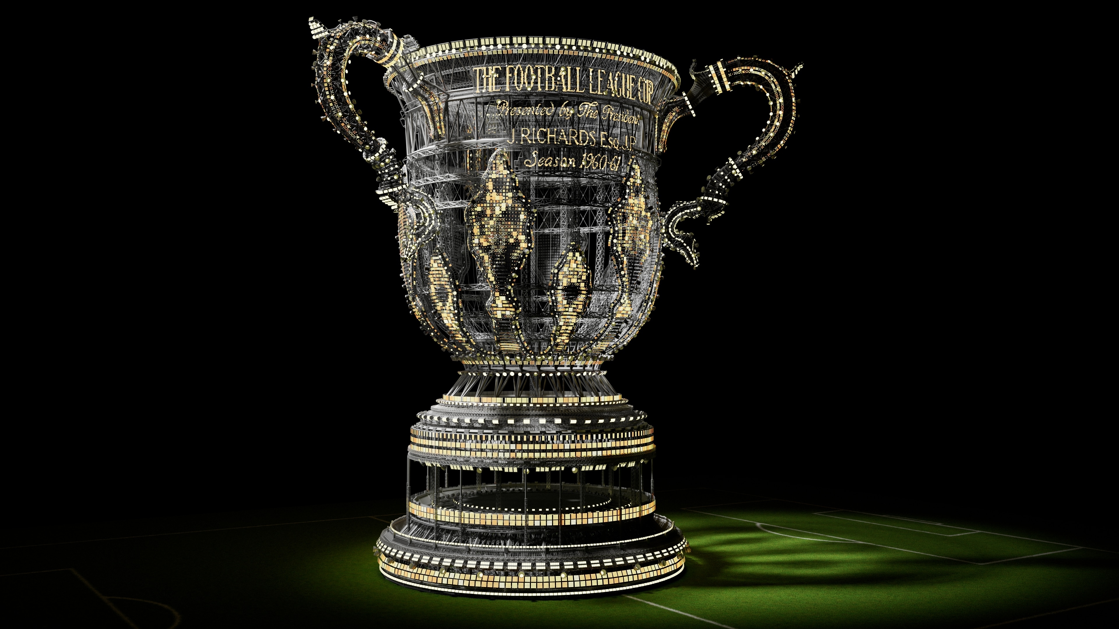 Procedural Carabao Cup rebuilt as a lattice superstructure of steel and gold lights, standing on a football pitch at night